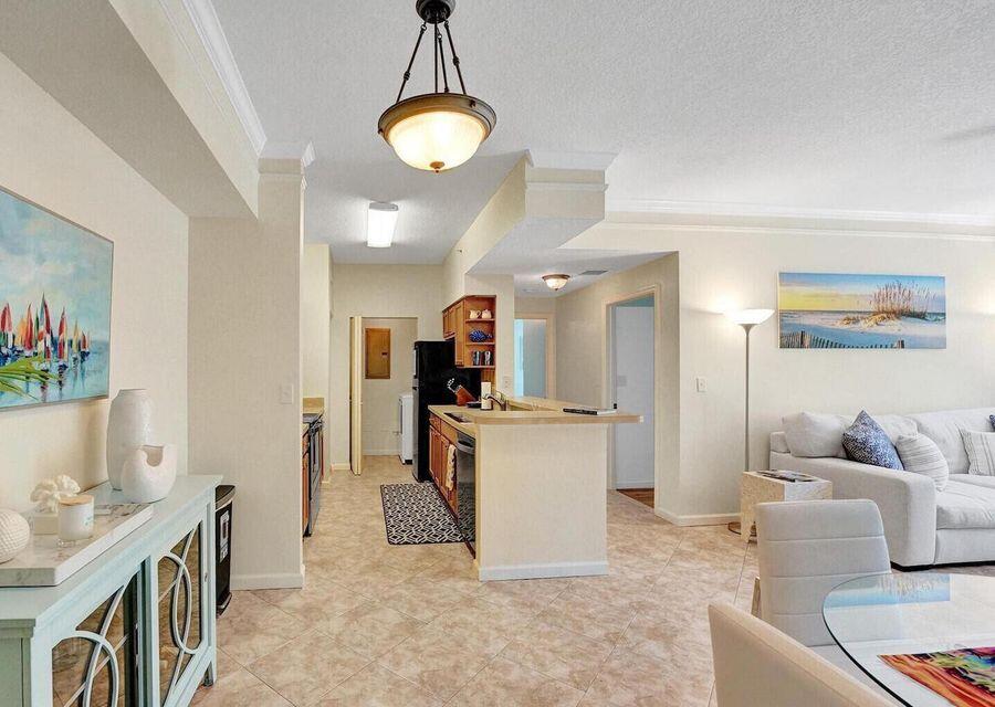 9857 Baywinds Boulevard, Unit 9302 West Palm Beach, FL 33411 - Photo 8 of 45 a living room with furniture and a table