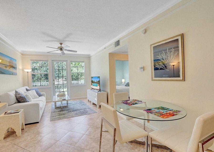 9857 Baywinds Boulevard, Unit 9302 West Palm Beach, FL 33411 - Photo 9 of 45 a living room with furniture and a large window