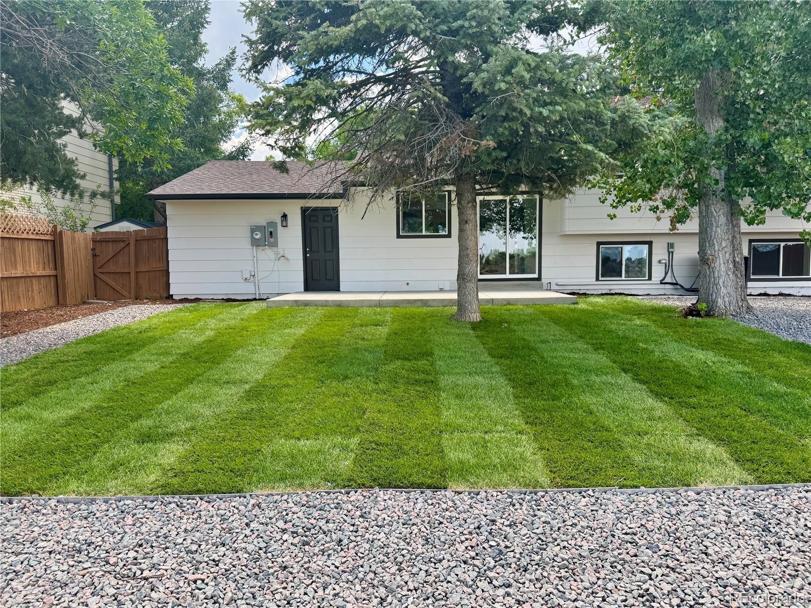 9260 Cody Lane Westminster, CO 80021 - Photo 18 of 18 front view of a house with a yard