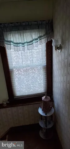 a view of backyard with wooden fence