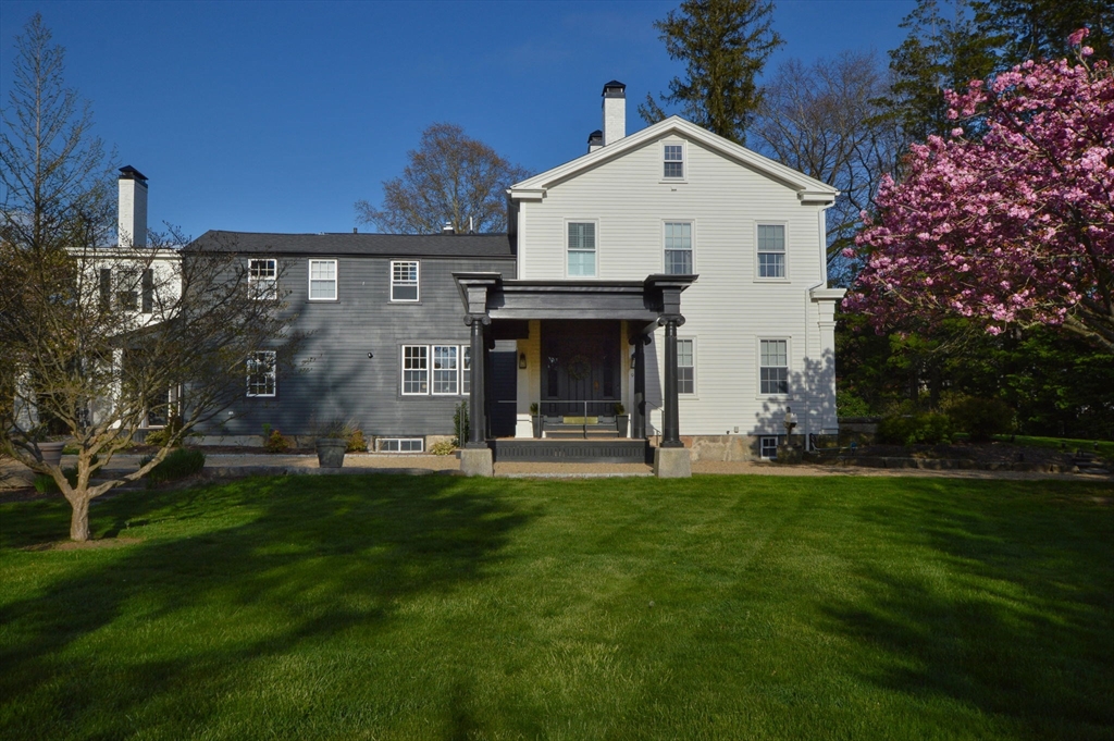 a front view of a house with a garden and plants