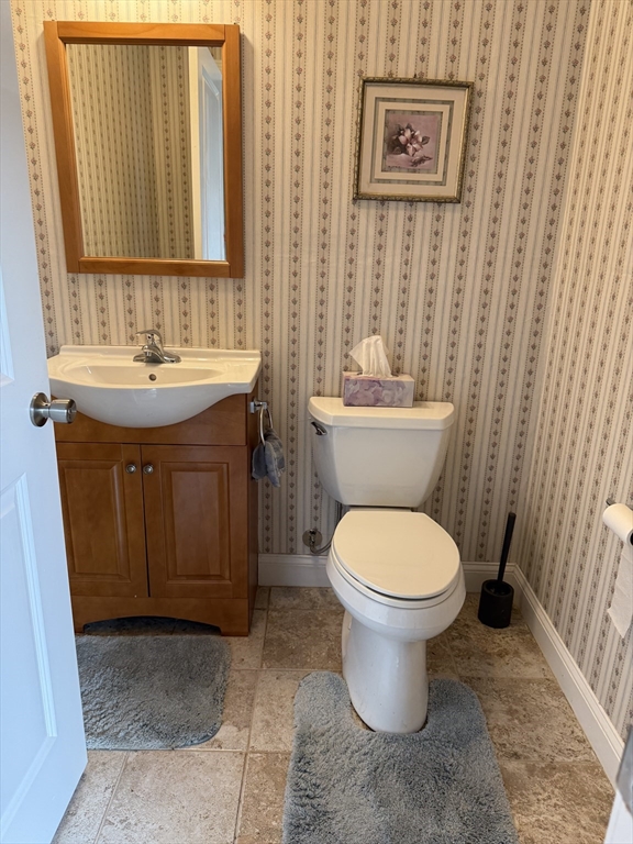 17 Lynwood Street Fall River, MA 02721 - Photo 17 of 28 a bathroom with a toilet sink and mirror