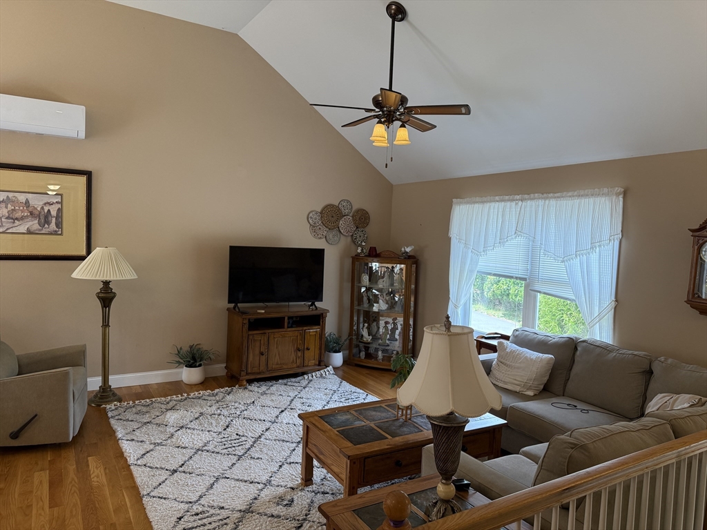 17 Lynwood Street Fall River, MA 02721 - Photo 4 of 28 a living room with furniture a chandelier and a flat screen tv