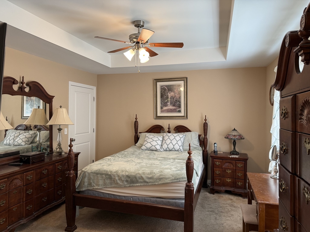 17 Lynwood Street Fall River, MA 02721 - Photo 10 of 28 a bedroom with a bed and a chandelier