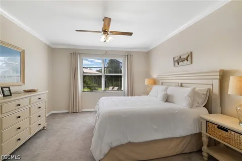 a bedroom with a bed and a ceiling fan