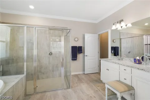 a bathroom with a granite countertop sink and a large mirror