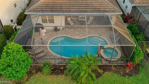 a view of a house with a yard and potted plants