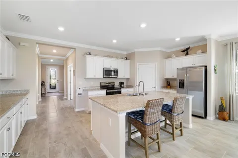 a kitchen with refrigerator cabinets dining table and chairs