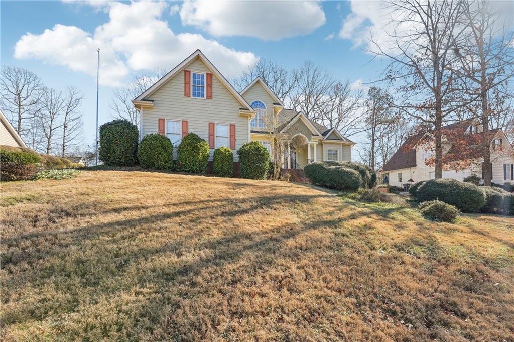 a front view of a house with a yard covered in snow