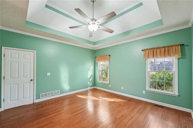 a view of empty room with wooden floor