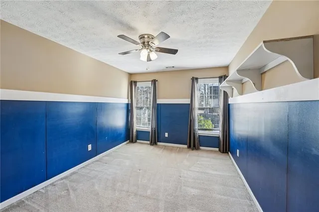 a large room with closet and windows