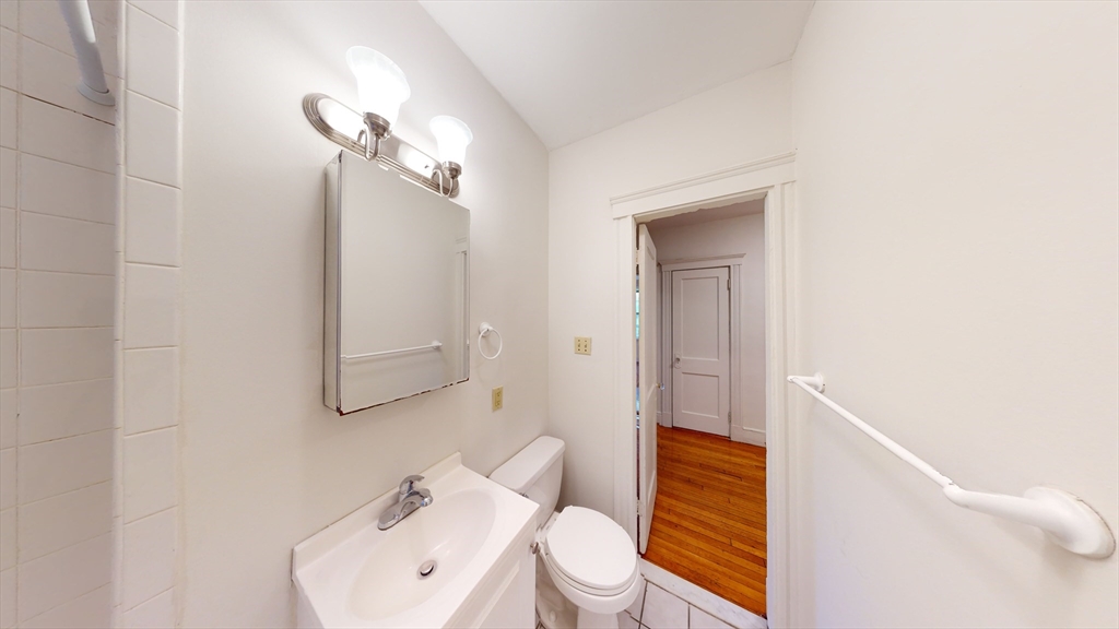 32 Sidlaw Road, Unit 7 Boston, MA 02135 - Photo 8 of 10 a bathroom with a sink a toilet and shower