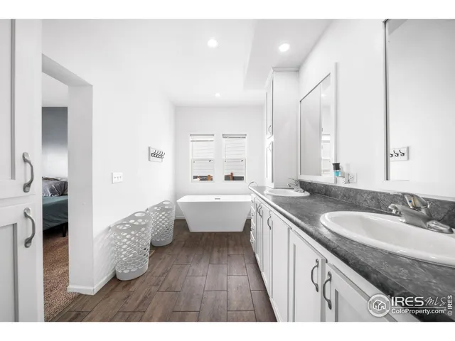 a large bathroom with a granite countertop sink and a mirror