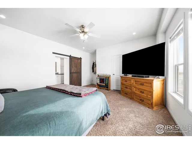 a kitchen with white cabinets and wooden floor