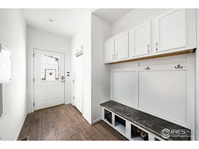 a kitchen with granite countertop a sink cabinets and wooden floor