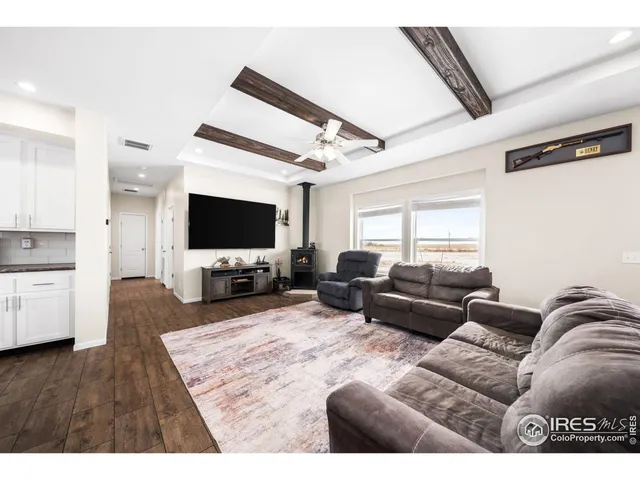 a kitchen with stainless steel appliances a refrigerator a stove top oven and white cabinets