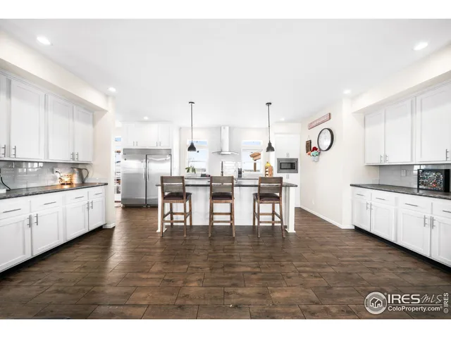 a kitchen with sink stove and cabinets