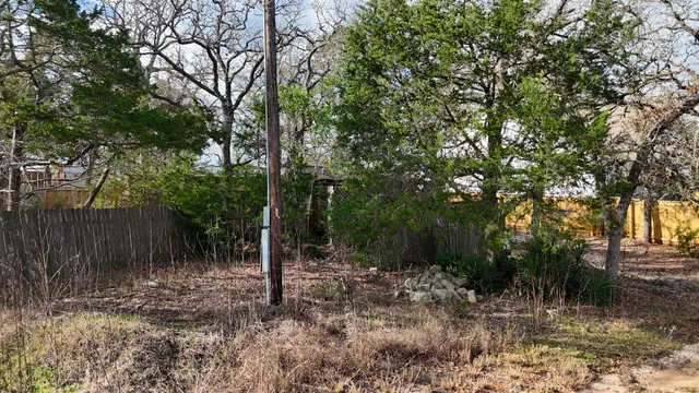 a backyard of a house with lots of trees