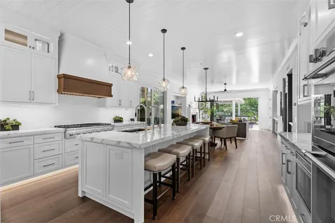 a kitchen with stainless steel appliances kitchen island a large island in the center