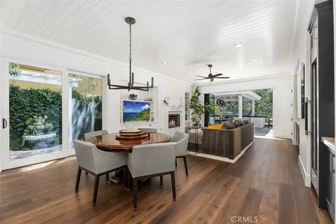 a dining room with furniture wooden floor and a chandelier