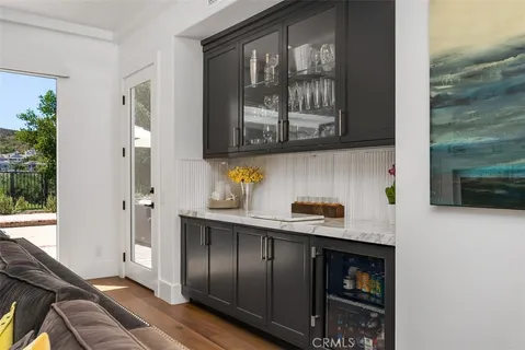 a kitchen with stainless steel appliances granite countertop a sink and a stove next to a window