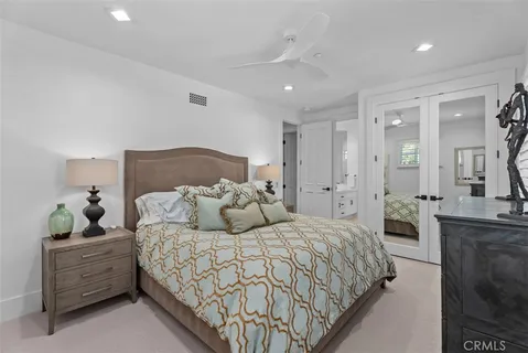 a large bedroom with a bed and a dresser