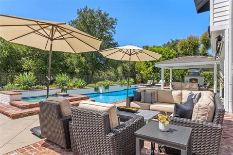 a view of an outdoor space with furniture and umbrella