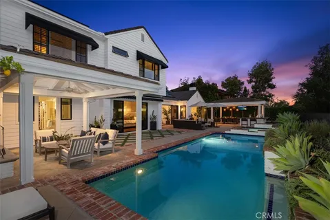 a view of a house with pool porch and sitting area