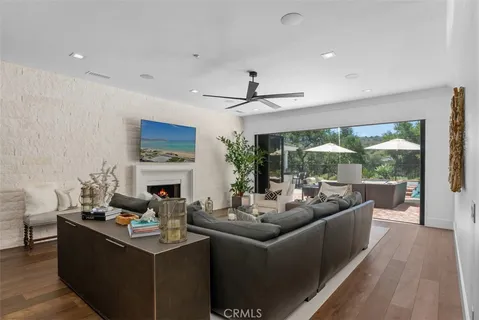 a living room with fireplace furniture and a large window