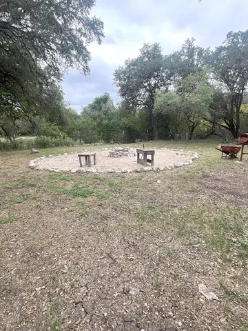 a backyard of a house with table and chairs