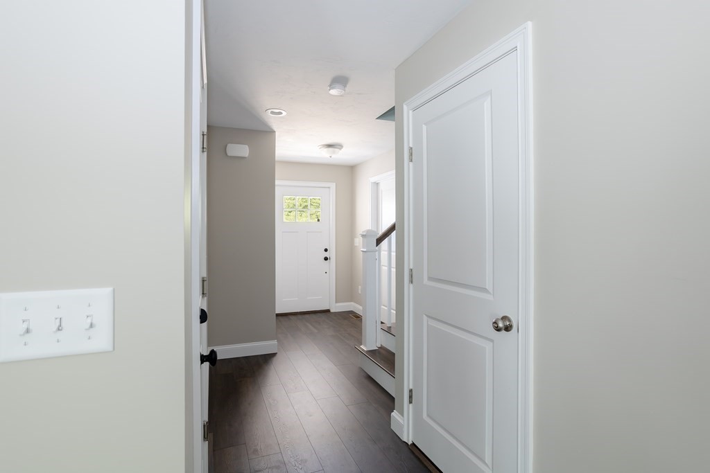 6 Katlyn Circle Rochester, MA 02770 - Photo 25 of 37 an empty room with wooden floor and a bathroom