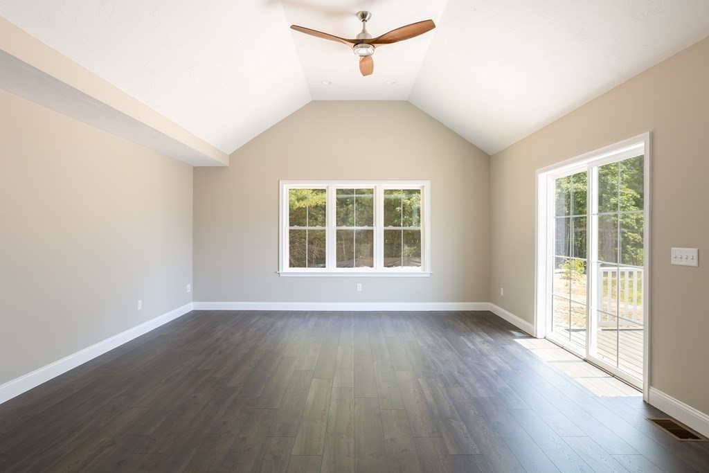 6 Katlyn Circle Rochester, MA 02770 - Photo 7 of 37 a view of an empty room with wooden floor and a window