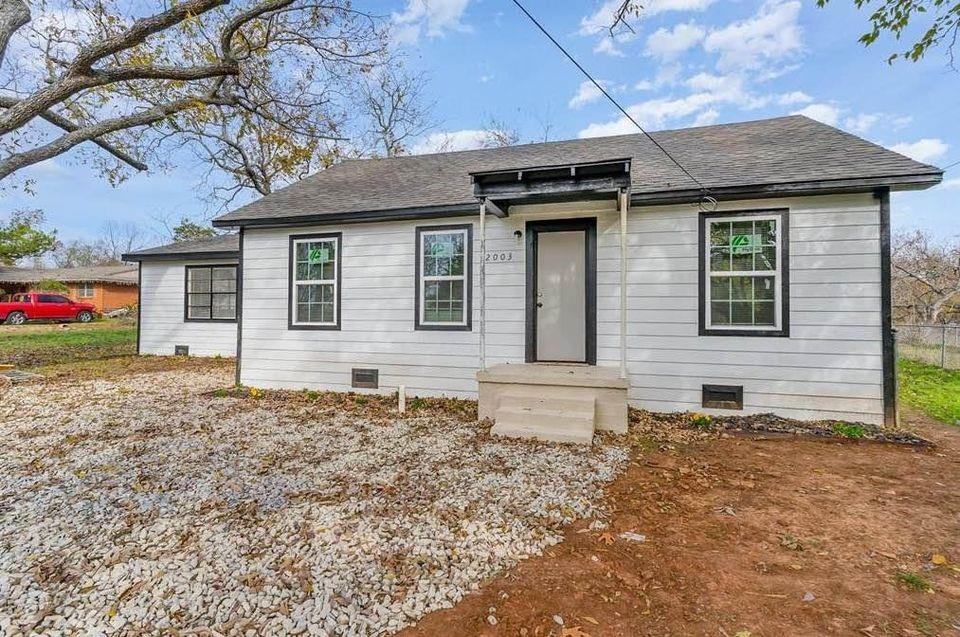 2003 West Bond Street Denison, TX 75020 - Photo 1 of 16 a front view of a house with garden