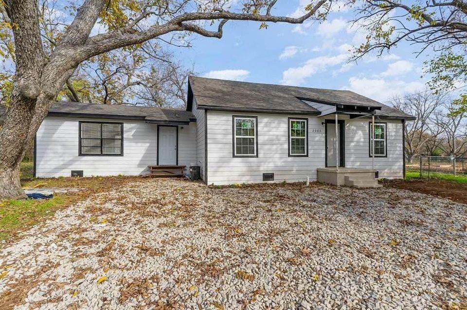 2003 West Bond Street Denison, TX 75020 - Photo 3 of 16 a front view of a house with a garden