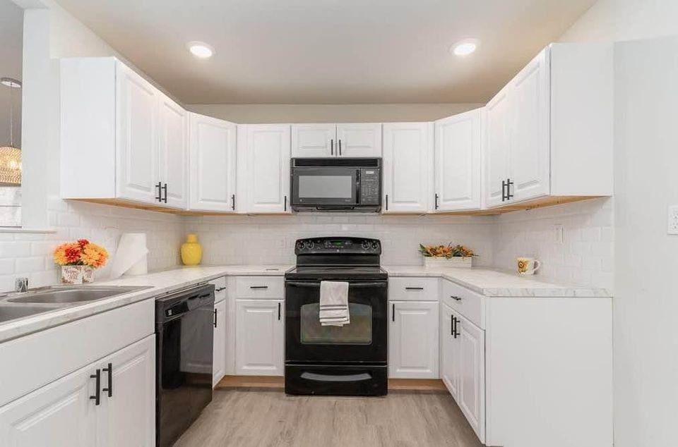 2003 West Bond Street Denison, TX 75020 - Photo 4 of 16 a kitchen with stainless steel appliances granite countertop a stove and a sink