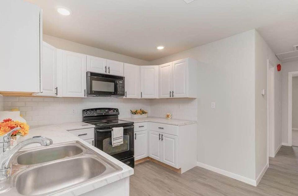 2003 West Bond Street Denison, TX 75020 - Photo 5 of 16 a kitchen that has a sink cabinets counter space and appliances