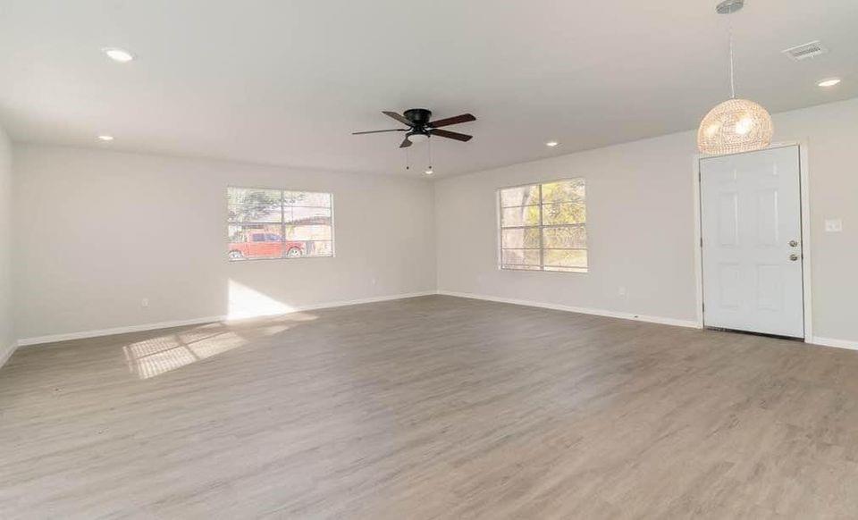 2003 West Bond Street Denison, TX 75020 - Photo 7 of 16 an empty room with wooden floor and windows