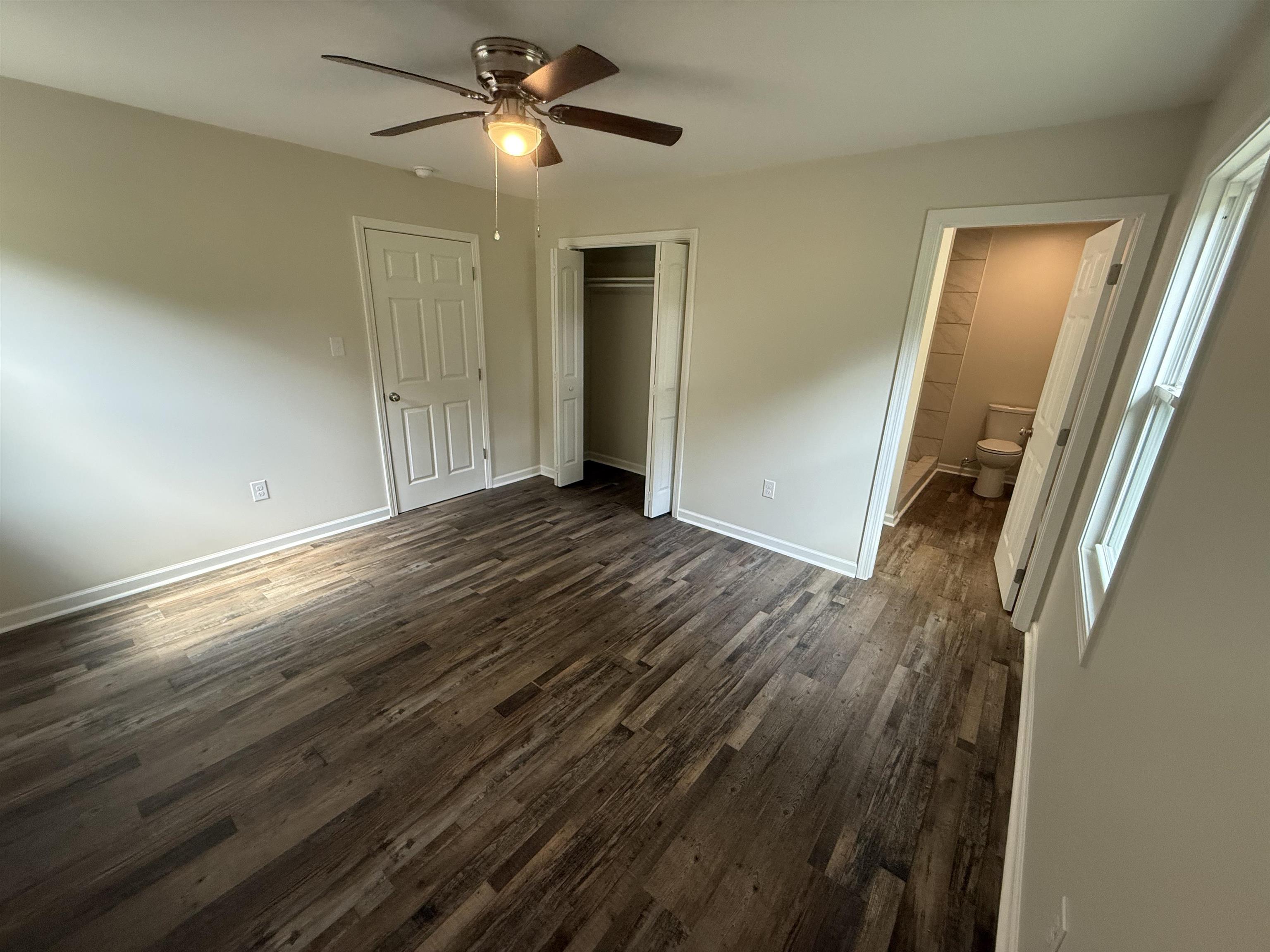1835 Pleasant Grove Road Moscow, TN 38057 - Photo 14 of 34 Room featuring wood-finish flooring, a ceiling fan with light fixture, and neutral painted walls