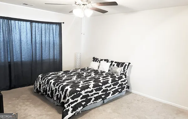 a bed sitting in a bedroom next to a window