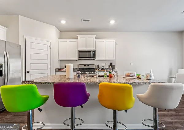 a kitchen with stainless steel appliances granite countertop a counter space and cabinets