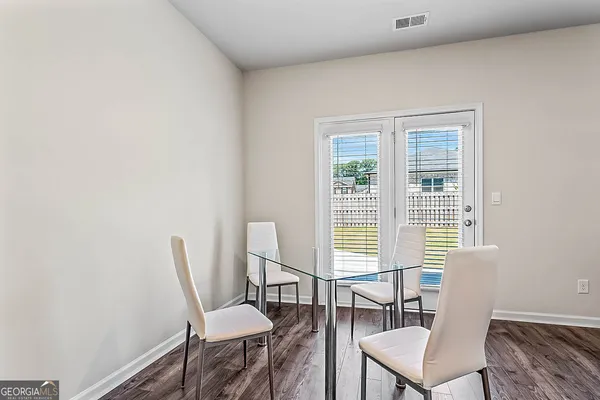 a view of a livingroom with a chair and dining table