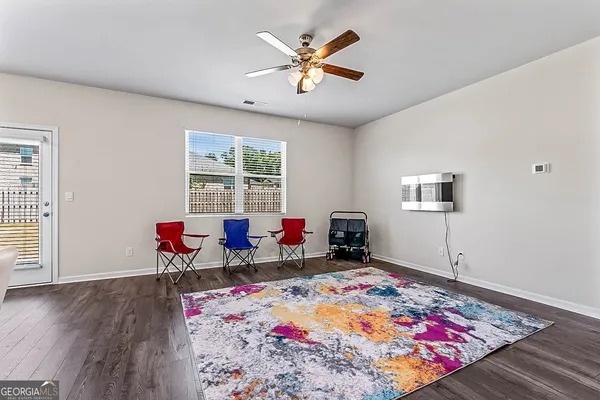 a living room with furniture rug and window