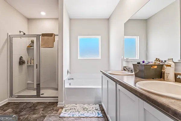 a bathroom with a granite countertop sink mirror and shower