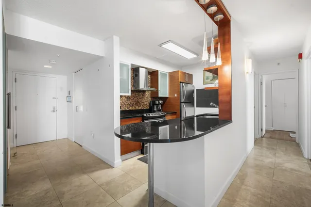 a kitchen with a sink and a refrigerator