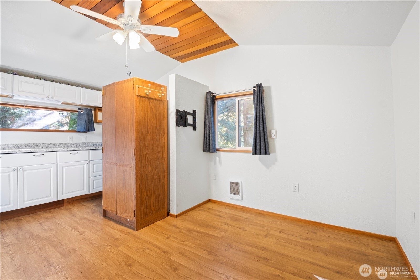 14310 200th Avenue Southeast Renton, WA 98058 - Photo 10 of 39 a view of a room with closet and wooden floor