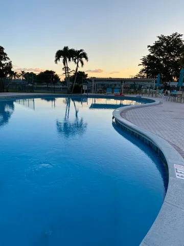 a view of swimming pool with table and chair