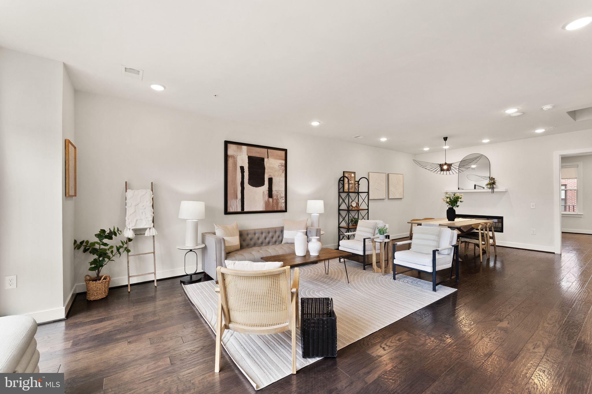 1867 Michael Faraday Drive, Unit 4 Reston, VA 20190 - Photo 2 of 53 a living room with furniture and a wooden floor