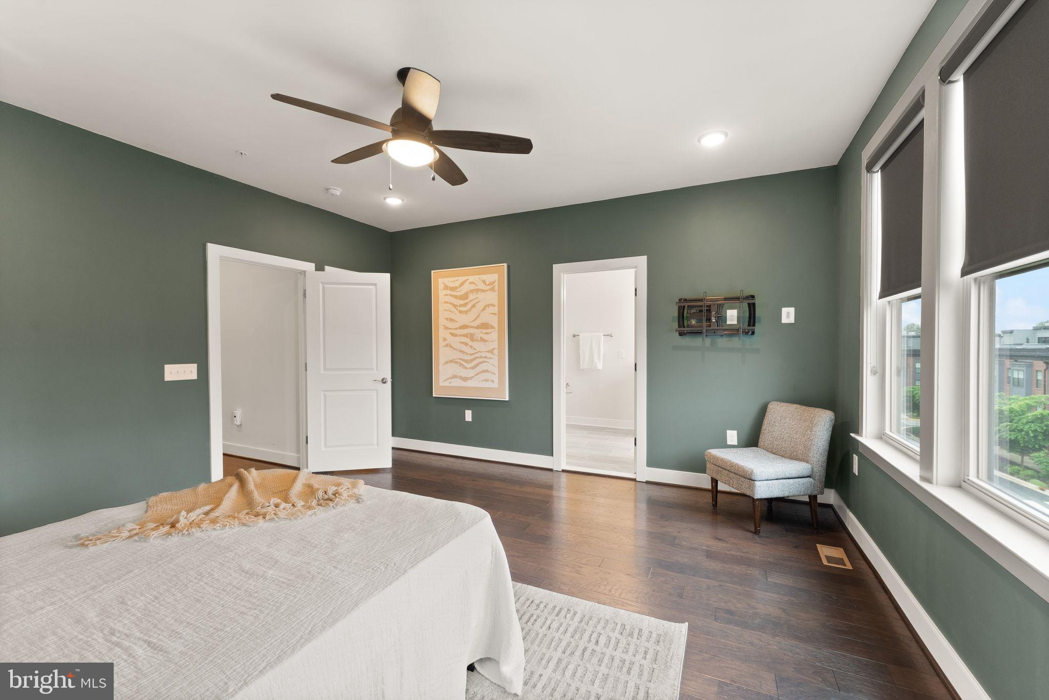 1867 Michael Faraday Drive, Unit 4 Reston, VA 20190 - Photo 32 of 53 a bedroom with a bed and wooden floor