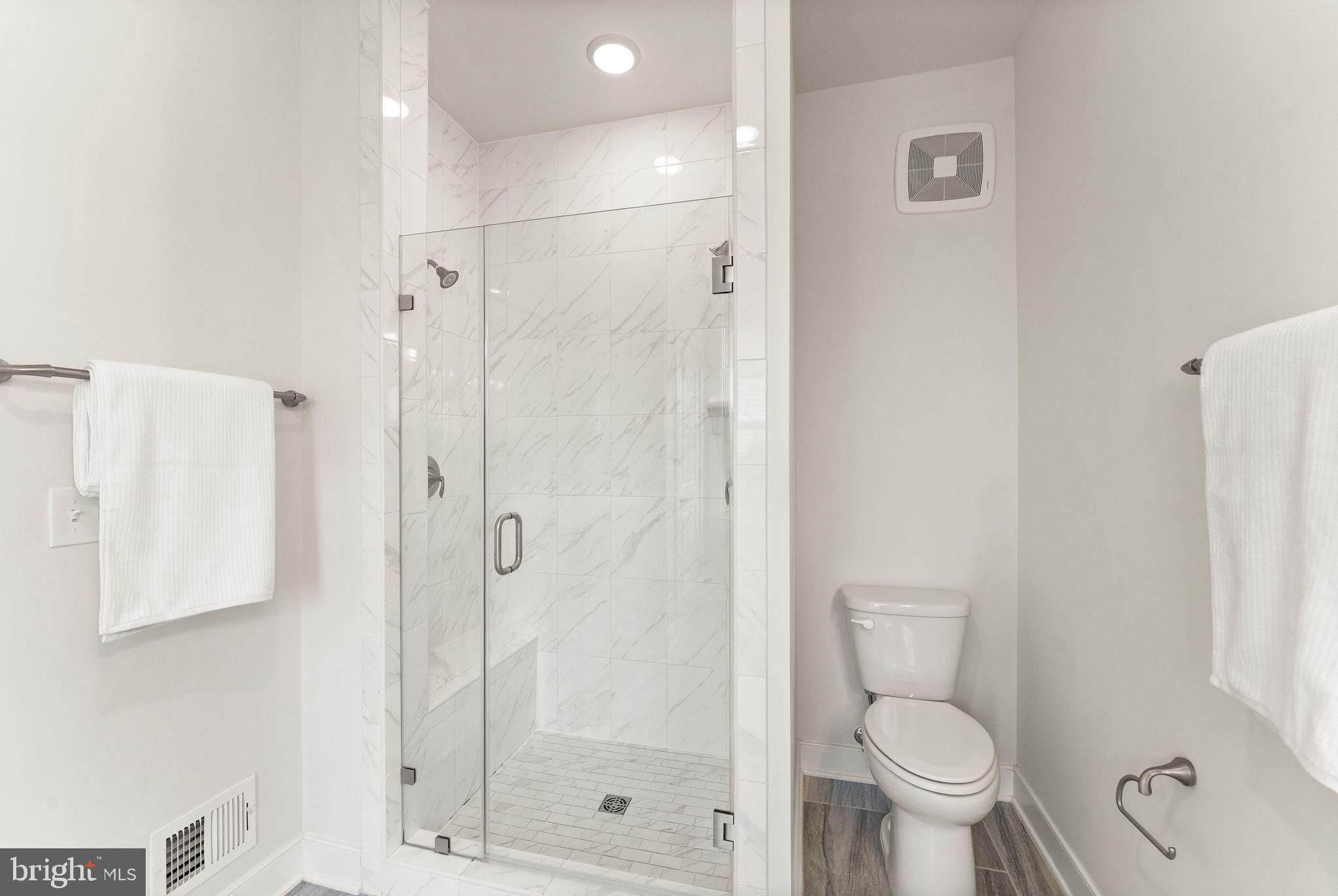 1867 Michael Faraday Drive, Unit 4 Reston, VA 20190 - Photo 35 of 53 a bathroom with a toilet and a shower