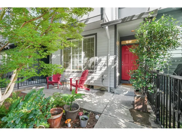 a view of a chair and tables in the back yard of the house